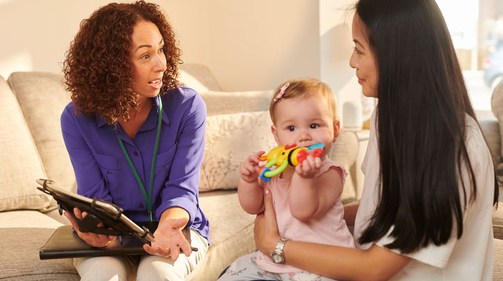 healthcare social worker at home visit with young mother