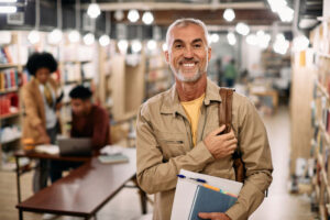 older male student smiling on campus