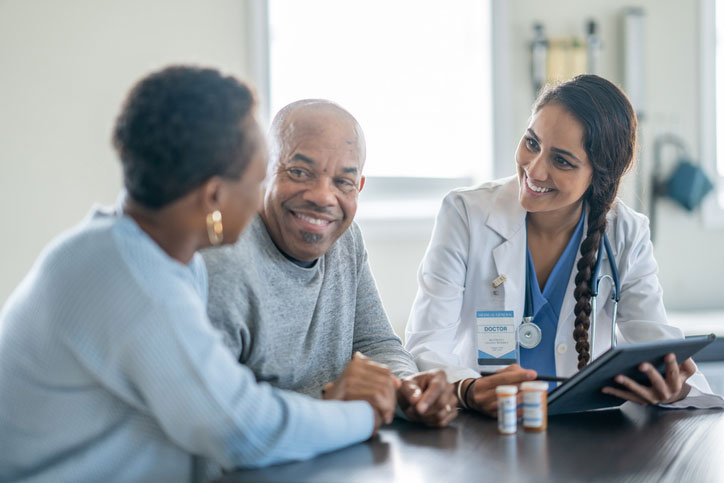 healthcare social worker talking with elderly couple