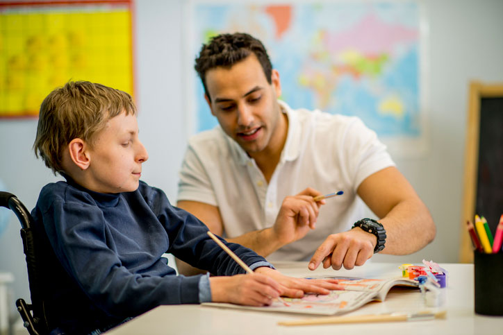 helping young boy at school