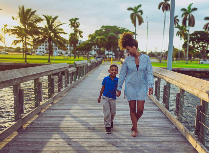 young boy walking with his mom