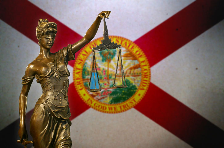 lady justice in front of florida state flag