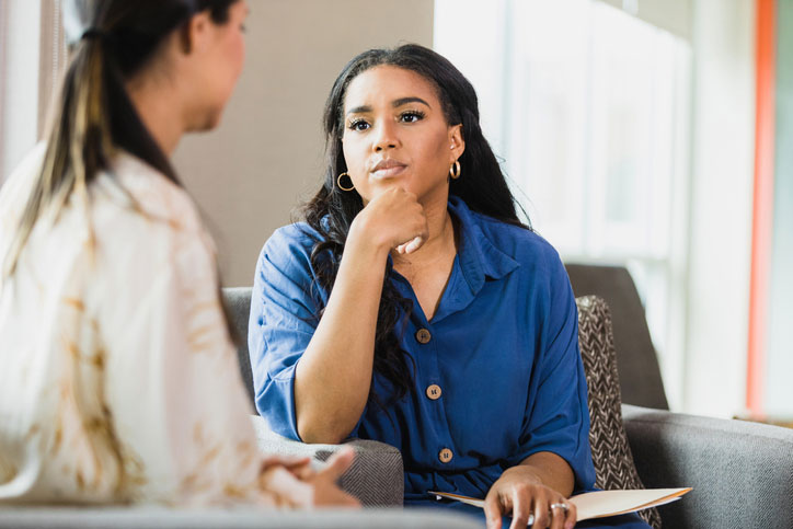 concerned therapist working with female social worker