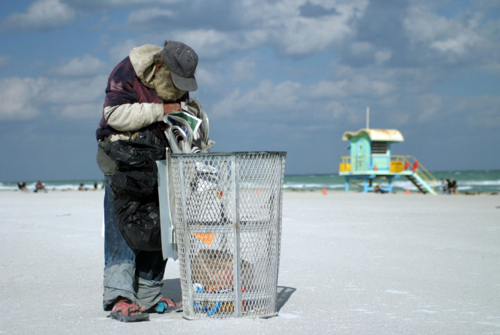 unhoused going through the garbage at the beach