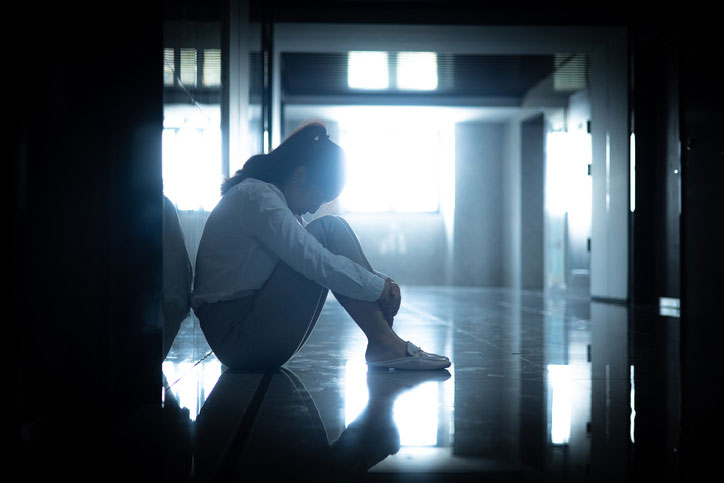 sad woman in dark corridor