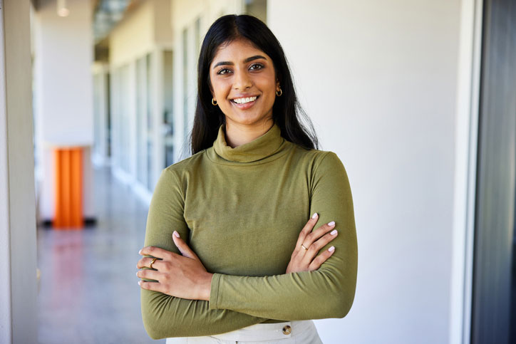 smiling young woman posing outside class