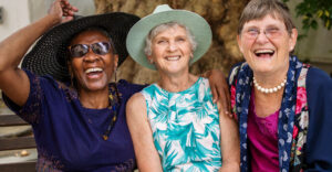 three elderly girlfriends having fun together