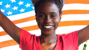 young woman with flag behind her