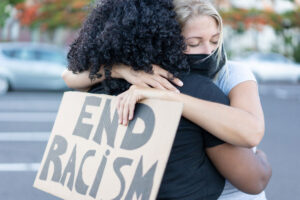 two women hugging during a protest