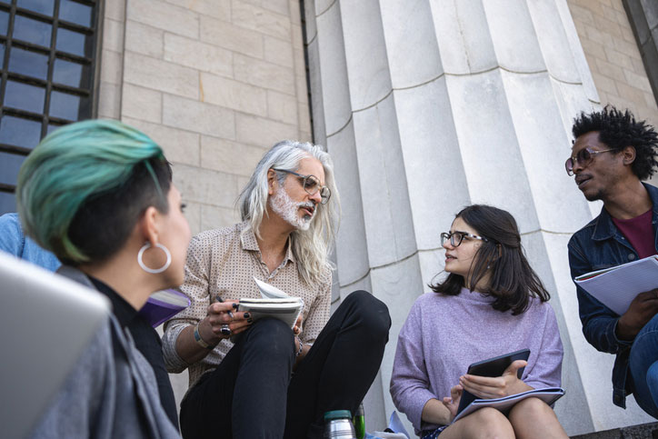 class professor talking with students outside