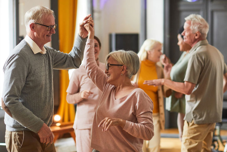 older couples dancing in a retirement facility