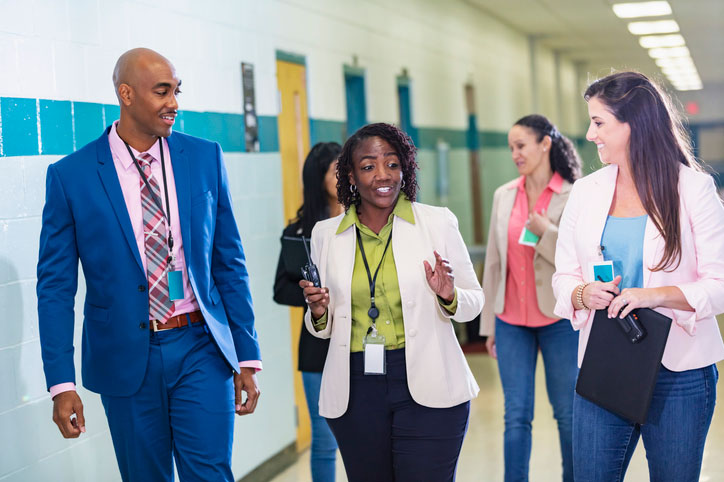 social workers walking and talking in the school halls