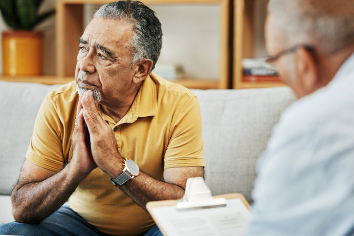 elderly man talking with a social worker