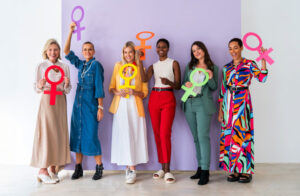 group of women holding femininity symbol