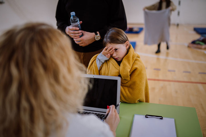 social worker talking with refugee in shelter