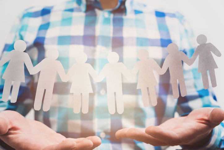 man holding paper people in hands