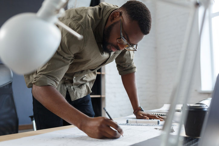 architect working on plans on job site