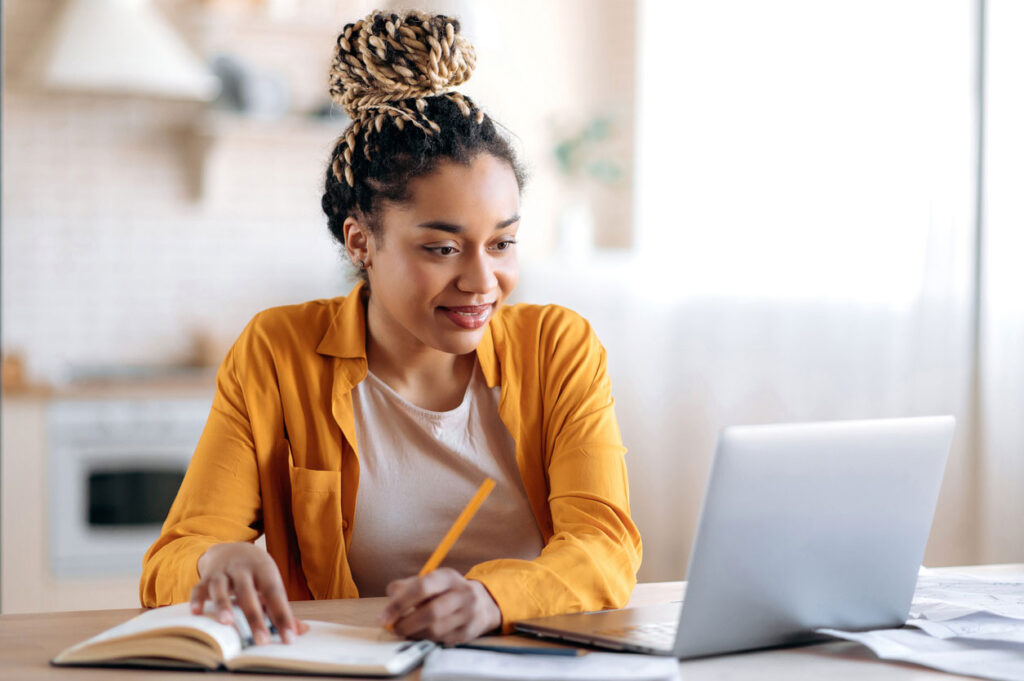 young woman working on homework from home